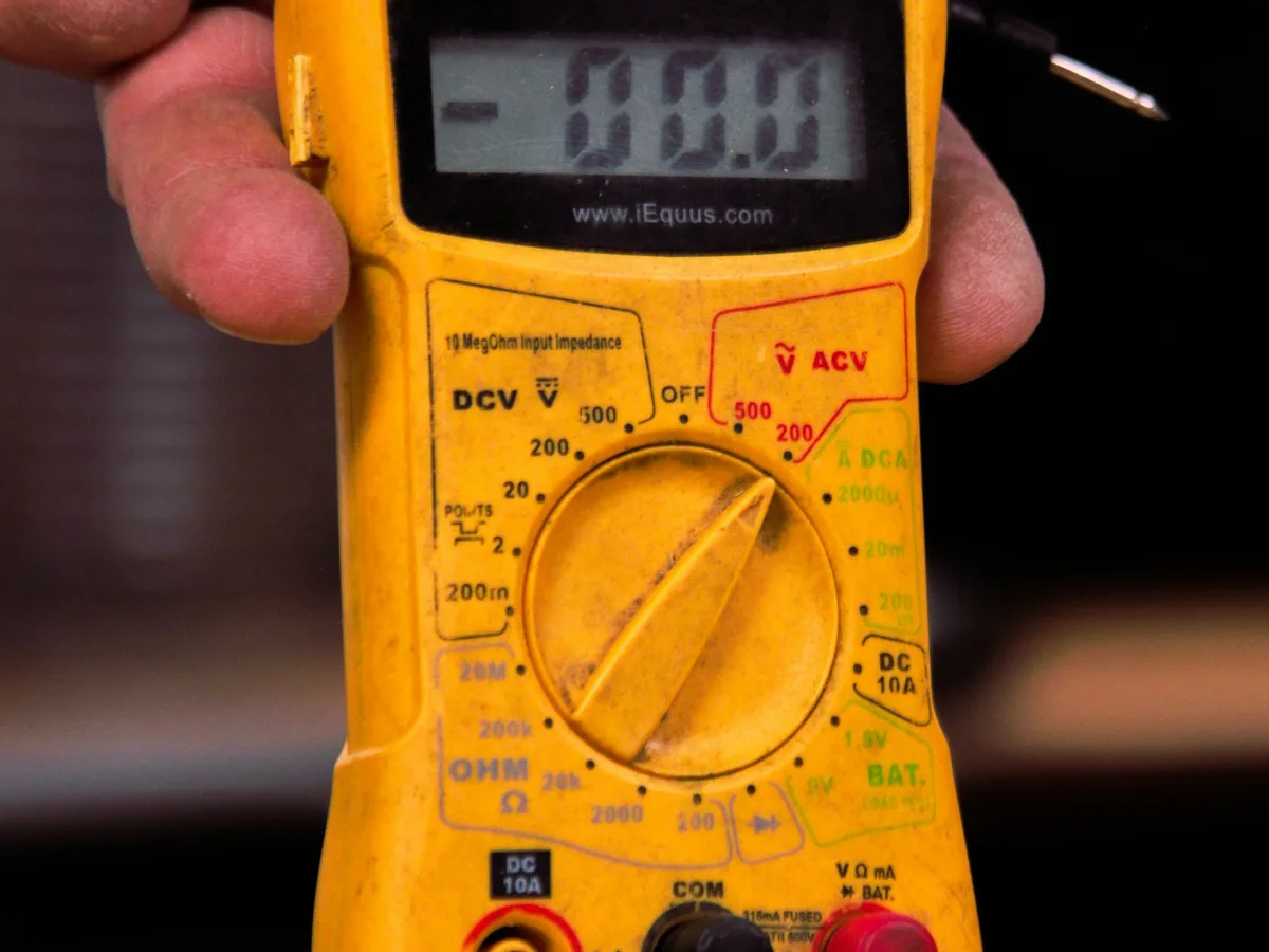 Technician running a multi-point inspection on a Generac standby generator with a diagnostic tool in Atlanta, GA