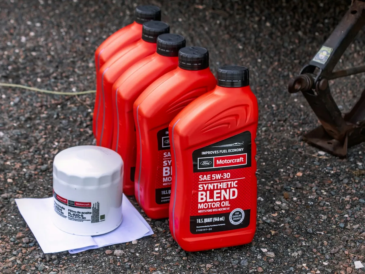 Fresh full-synthetic oil being poured into a Generac generator engine during a seasonal oil change in Atlanta, GA
